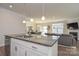 Spacious kitchen with granite island, stainless steel dishwasher, and view to the living room at 4246 Millstream Rd, Denver, NC 28037