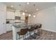 Modern kitchen featuring a large island, stainless steel appliances, and white cabinets at 4246 Millstream Rd, Denver, NC 28037