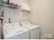 Practical laundry room with washer, dryer, and shelving at 4246 Millstream Rd, Denver, NC 28037