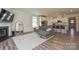 Bright living room with hardwood floors, fireplace, television, and connected to the kitchen at 4246 Millstream Rd, Denver, NC 28037