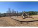 Community playground with a slide, climbing structure, and wood chip ground cover at 4246 Millstream Rd, Denver, NC 28037