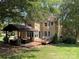 Backyard view of the house with a large yard, deck, and covered entertaining area at 4825 1St Street Nw Ct, Hickory, NC 28601