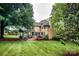 Spacious backyard featuring a covered deck and lush greenery, ideal for outdoor enjoyment at 4825 1St Street Nw Ct, Hickory, NC 28601