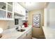 Stylish bar area featuring marble countertops, glass cabinets, and a convenient sink at 4825 1St Street Nw Ct, Hickory, NC 28601