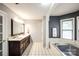 Spacious bathroom featuring double sinks, a large mirror, and tiled floors for convenience at 4825 1St Street Nw Ct, Hickory, NC 28601