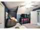 Large bonus room with a big comfy beanbag, mounted tv and bright light fixture at 4825 1St Street Nw Ct, Hickory, NC 28601