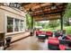 Outdoor deck featuring comfortable seating, a covered structure, and views of the landscaped yard at 4825 1St Street Nw Ct, Hickory, NC 28601