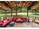 This covered deck features modern seating, outdoor fans and a TV, creating a relaxing outdoor space at 4825 1St Street Nw Ct, Hickory, NC 28601