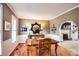 Inviting dining room with wood table and view into an adjacent living area featuring an archway at 4825 1St Street Nw Ct, Hickory, NC 28601