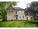 Stately two-story home with tan stucco, manicured lawn, and mature trees at 4825 1St Street Nw Ct, Hickory, NC 28601
