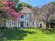 Beautiful two story home with manicured lawn framed by lush greenery and mature flowering trees, offering curb appeal at 4825 1St Street Nw Ct, Hickory, NC 28601