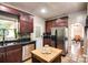 Cozy kitchen features stainless steel appliances, granite countertops, and warm wood cabinetry at 4825 1St Street Nw Ct, Hickory, NC 28601