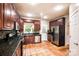 Stylish kitchen with dark wood cabinets, stainless appliances, and unique tile flooring at 4825 1St Street Nw Ct, Hickory, NC 28601