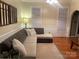 Inviting living room features a comfortable sectional sofa, warm lighting, and hardwood floors at 4825 1St Street Nw Ct, Hickory, NC 28601