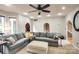 Open-concept living room with neutral tones, large sofa, and arched doorway to kitchen at 4825 1St Street Nw Ct, Hickory, NC 28601