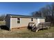 Back exterior view of home featuring a wooden deck and tan vinyl siding at 48344 Hwy 731 Hwy, Norwood, NC 28128