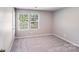 Cozy bedroom with neutral carpet, paint and a large window at 509 Holly St, Statesville, NC 28677