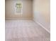 Spacious bedroom featuring neutral carpet, paint, and natural light at 509 Holly St, Statesville, NC 28677