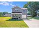 Charming two-story home with well-maintained lawn, driveway and an attached one car garage at 509 Holly St, Statesville, NC 28677