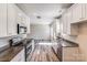 Contemporary kitchen boasts granite countertops and stainless steel appliances at 509 Holly St, Statesville, NC 28677