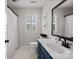 Modern bathroom with a blue vanity, framed mirror and a shower with curtain at 5421 Woodcreek Dr, Charlotte, NC 28226