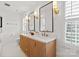 Bright bathroom with double vanity, decorative mirrors, and modern fixtures at 5421 Woodcreek Dr, Charlotte, NC 28226