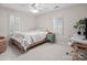 Well-lit bedroom with desk, ceiling fan and natural light from shuttered windows at 5421 Woodcreek Dr, Charlotte, NC 28226