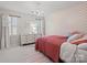 Stylish bedroom with decorative heart accent wall, chandelier, and dresser at 5421 Woodcreek Dr, Charlotte, NC 28226