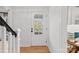Bright entryway featuring a white front door with glass panes and wood floors at 5421 Woodcreek Dr, Charlotte, NC 28226