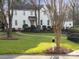 Charming two-story home with landscaped yard and brick walkway to front door at 5421 Woodcreek Dr, Charlotte, NC 28226