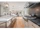 The open concept kitchen features a gas range, kitchen island, and a view into the dining room at 5421 Woodcreek Dr, Charlotte, NC 28226