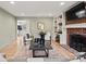 Spacious living room with fireplace, built-in shelving, and hardwood floors at 5421 Woodcreek Dr, Charlotte, NC 28226