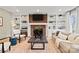 Stylish living room featuring a brick fireplace, built-in shelving, and modern decor at 5421 Woodcreek Dr, Charlotte, NC 28226
