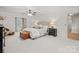 Spacious main bedroom with neutral tones, a ceiling fan, and large windows at 5421 Woodcreek Dr, Charlotte, NC 28226