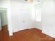This bright bedroom features hardwood floors, neutral walls and a spacious double-door closet at 5963 Pale Moss Ln, Charlotte, NC 28269
