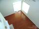 Bright bedroom with hardwood floors, large window and sliding glass door at 5963 Pale Moss Ln, Charlotte, NC 28269