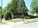 Well-maintained community entrance with stone signage and mature landscaping, providing a welcoming atmosphere at 5963 Pale Moss Ln, Charlotte, NC 28269