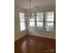 Elegant dining room with hardwood floors, a crystal chandelier, and abundant natural light, perfect for Gathering meals at 5963 Pale Moss Ln, Charlotte, NC 28269