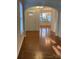 Bright entryway with hardwood floors, showcasing an elegant chandelier and open flow to the living spaces at 5963 Pale Moss Ln, Charlotte, NC 28269