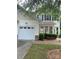 Two-story home with light colored siding, garage, and well landscaped lawn at 5963 Pale Moss Ln, Charlotte, NC 28269