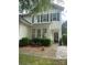 Charming two-story home featuring a welcoming front porch and well-maintained landscaping, creating excellent curb appeal at 5963 Pale Moss Ln, Charlotte, NC 28269