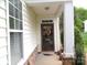 Inviting front porch with decorative door and stone accents, enhancing the home's charm and curb appeal at 5963 Pale Moss Ln, Charlotte, NC 28269