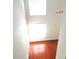 Bright hallway features hardwood floors, natural light from the skylight, and neutral paint at 5963 Pale Moss Ln, Charlotte, NC 28269