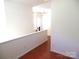 Spacious hallway with wood floors, white walls, and ample natural light at 5963 Pale Moss Ln, Charlotte, NC 28269
