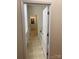 Bright hallway featuring neutral walls and flooring, showcasing access to other rooms at 5963 Pale Moss Ln, Charlotte, NC 28269