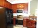 Functional kitchen area with stainless steel appliances, including a refrigerator and oven, plus wooden cabinetry at 5963 Pale Moss Ln, Charlotte, NC 28269
