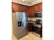 Well-equipped kitchen featuring stainless steel appliances and warm wood cabinetry at 5963 Pale Moss Ln, Charlotte, NC 28269
