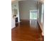 Spacious living room with hardwood floors, a cozy fireplace, and natural light, perfect for relaxation and entertaining at 5963 Pale Moss Ln, Charlotte, NC 28269