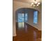 Open-concept living area featuring hardwood floors, large windows, and a sliding glass door to the backyard, great for gatherings at 5963 Pale Moss Ln, Charlotte, NC 28269