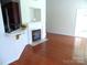 Inviting living area with hardwood floors, fireplace, and bar, creating a warm and welcoming atmosphere at 5963 Pale Moss Ln, Charlotte, NC 28269